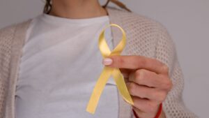 Woman holding yellow ribbon