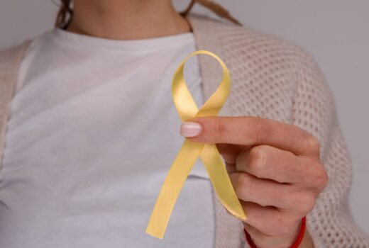 Woman holding yellow ribbon