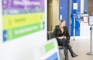 Woman sitting in NHS waiting area